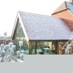 An air dried oak frame extension looked from the outside in the garden where you can see the roof.