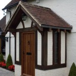 An air dried oak porch with wooden door from the right