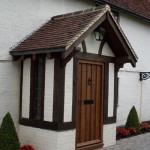 An air dried oak porch with wooden door from the left