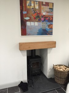 Oak mantel fitted above the fireplace.