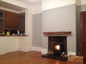 Oak Fireplace Mantels in a living room without furniture.
