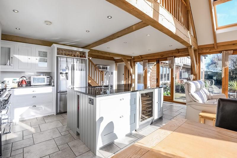 White open kitchen space under the oak frame maisonette