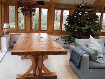 A solid oak dining table with unique braces.