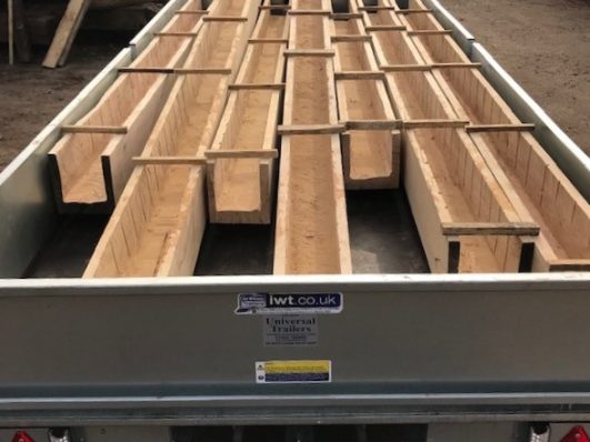 U-shaped oak beams being transported