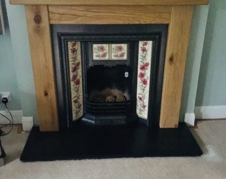 Oak mantel fitted above the fireplace.