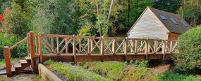 Bridge-made-my-encapsulating-steel-frame-in-oak-scaled-optimized