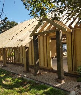 oak garage and garden room in the middle of being built.