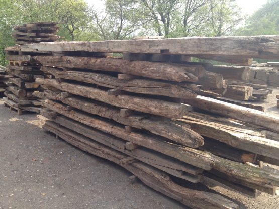 Reclaimed oak beams in yard