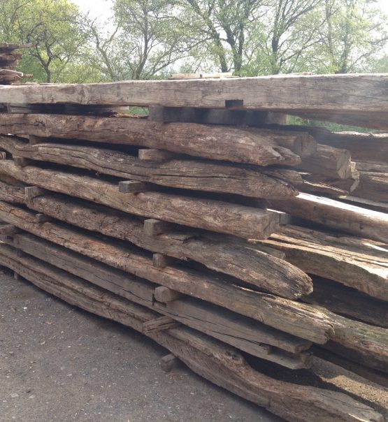 Reclaimed oak beams in yard